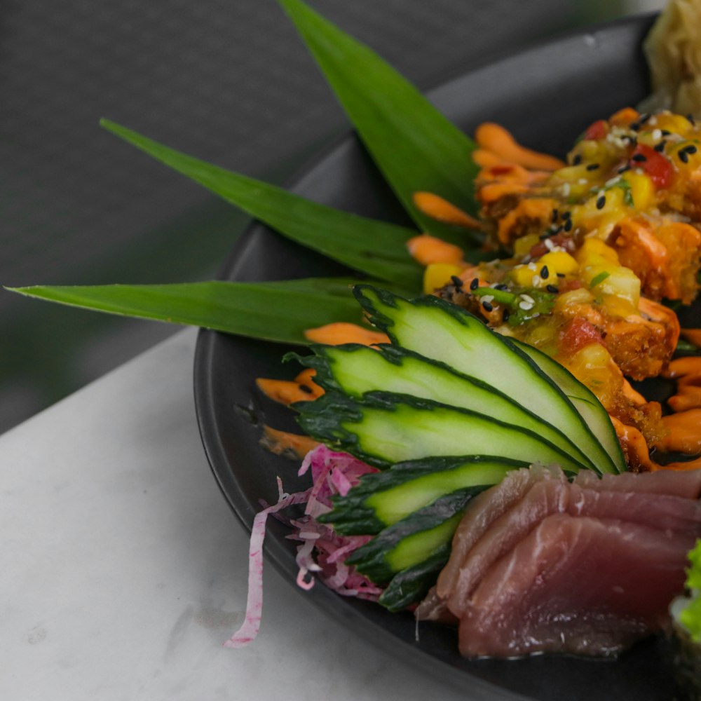 green and orange vegetable on black ceramic bowl