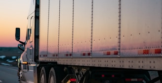 white freight truck on road during daytime