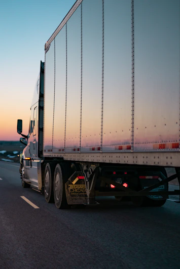 Tractor trailer outfitted with rugged accessories driving on an open highway