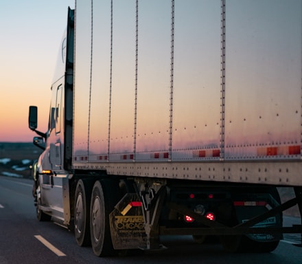 white freight truck on road during daytime