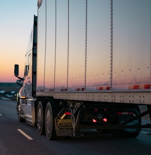 white freight truck on road during daytime