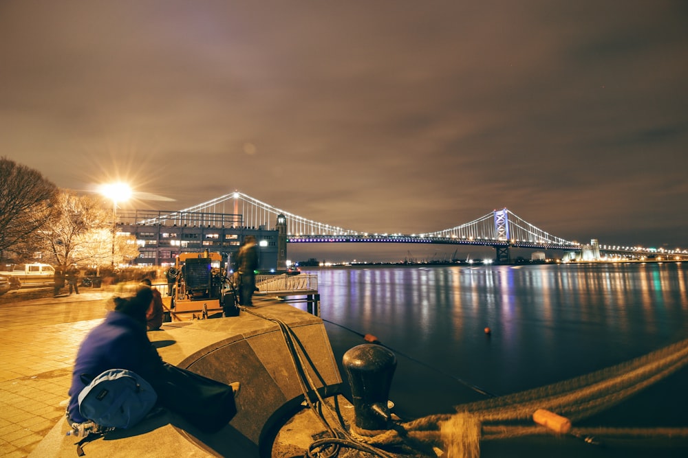 people walking on bridge during night time