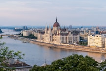 brown concrete building near body of water during daytime