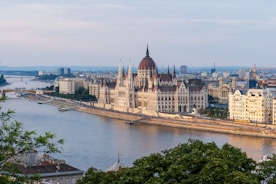 brown concrete building near body of water during daytime