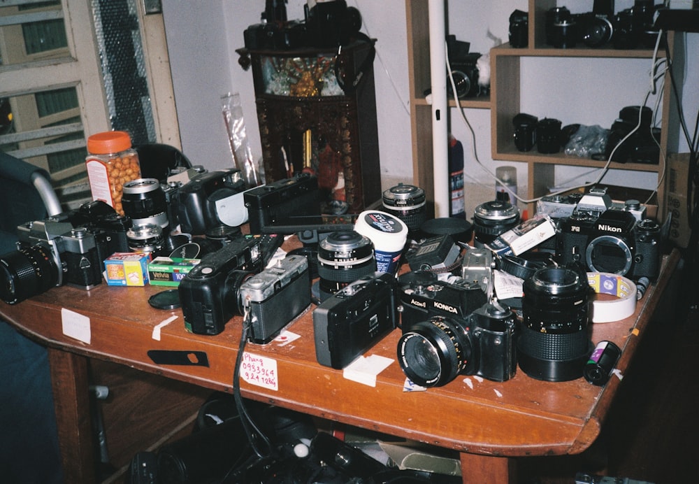 black and silver camera on brown wooden table