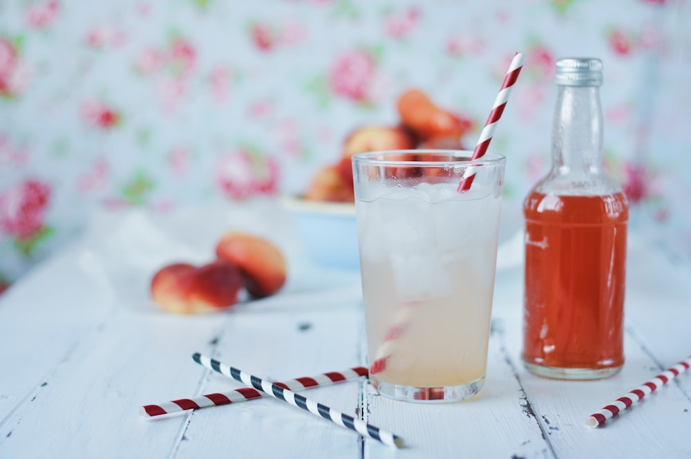 clear drinking glass with orange liquid