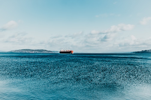 brown ship on blue sea under blue sky during daytime