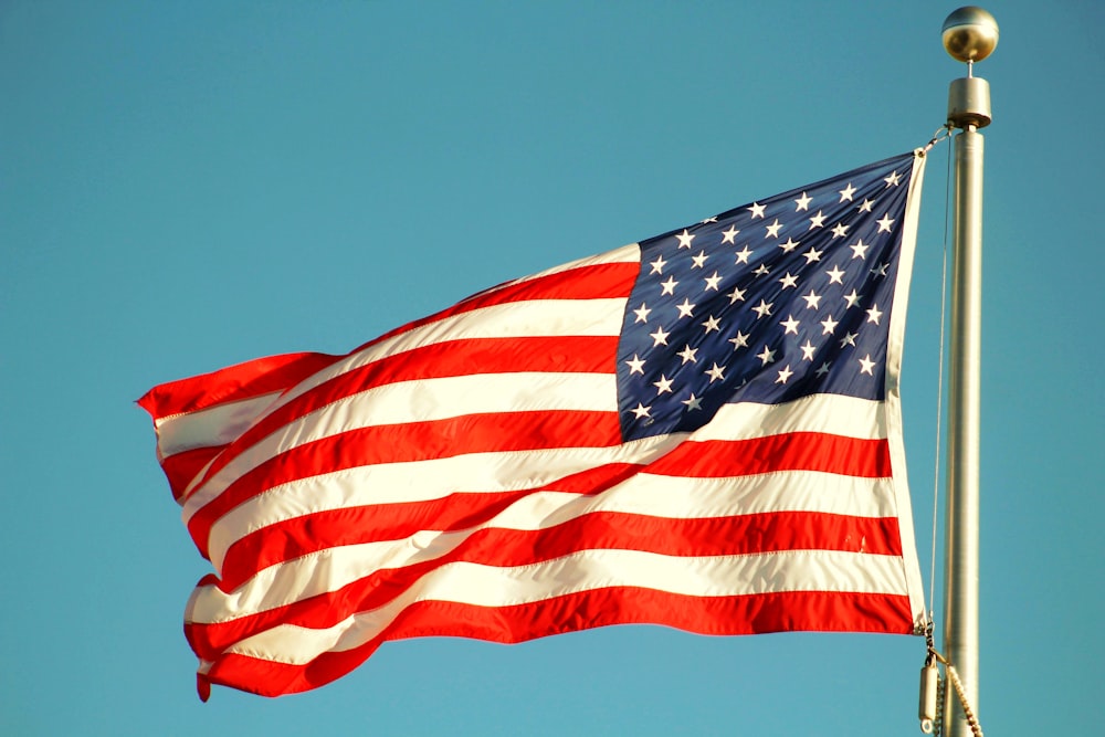 us a flag under blue sky during daytime