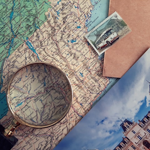 A physical map with a magnifying glass.