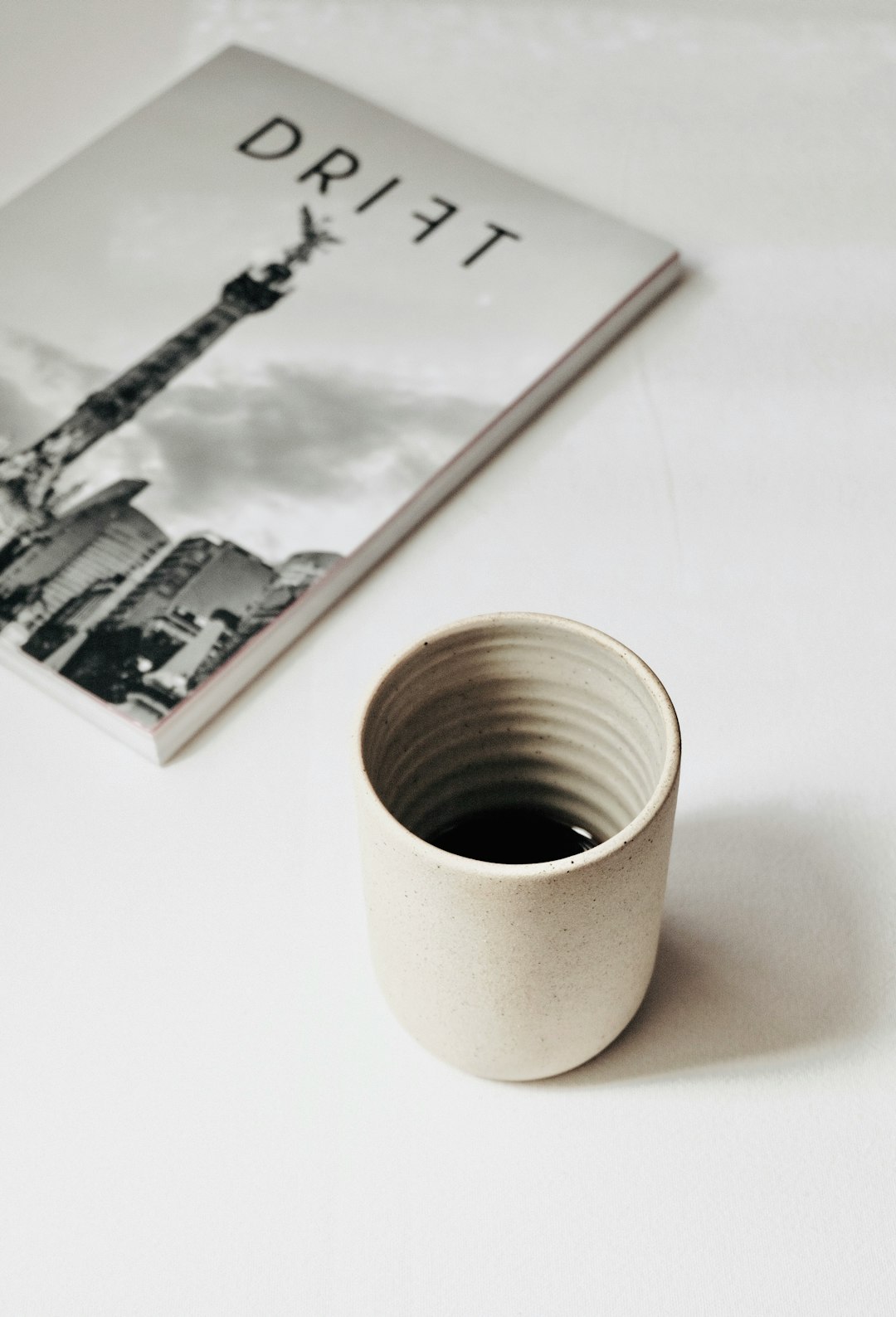 white ceramic mug on white table