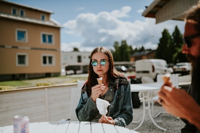 Happy family enjoying ice cream together at a cozy outdoor table.