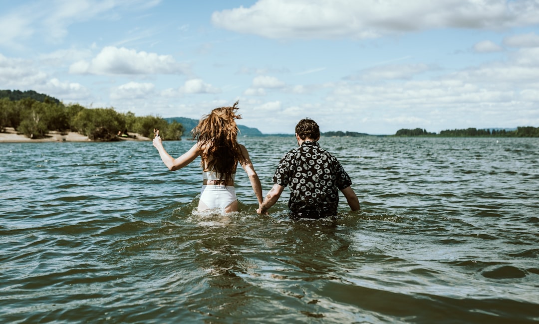 man and woman in white dress on water during daytime