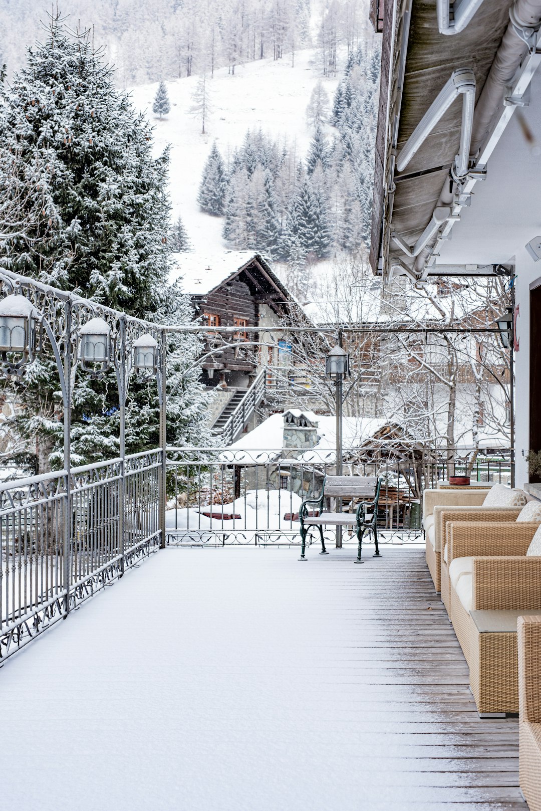 brown wooden chairs and tables on snow covered ground