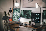 A vibrant workspace showing a gaming chair and dual monitors with tech gadgets around