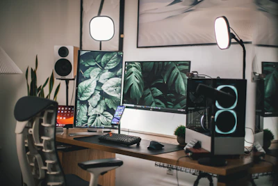 A finished workstation setup featuring a custom-built PC, dual monitors, and ergonomic accessories in a modern office space.