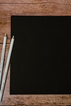 A minimalist black and white photo showing a clean grid layout sketch on paper.