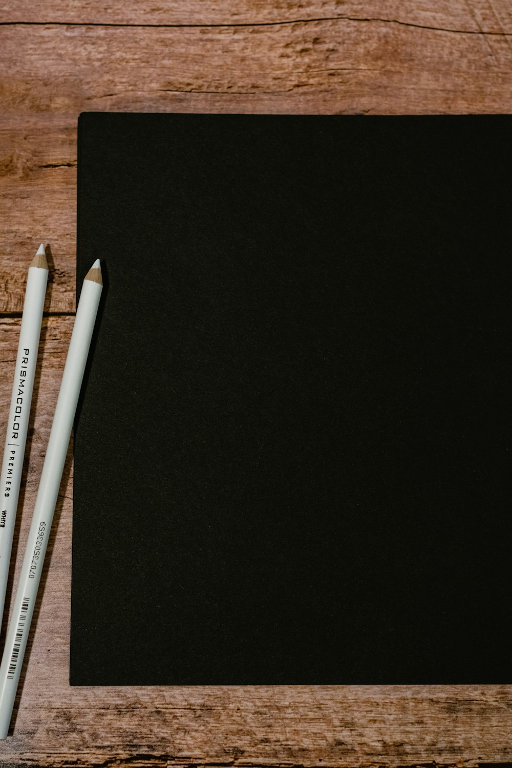 white and gray pencils on black textile