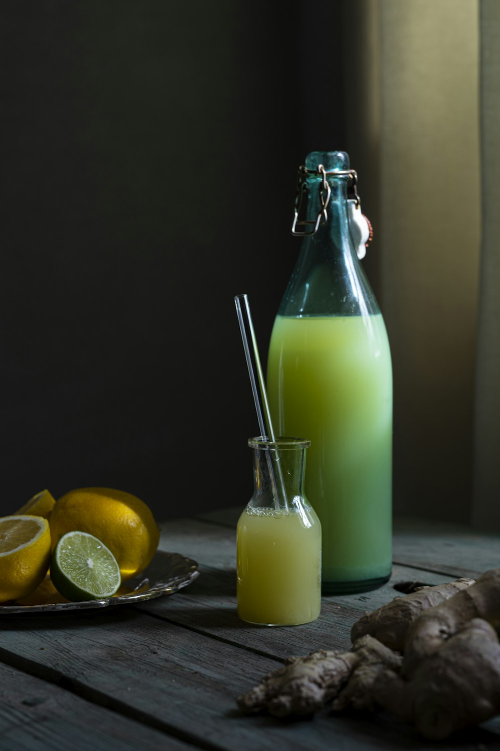 clear glass bottle with green liquid inside