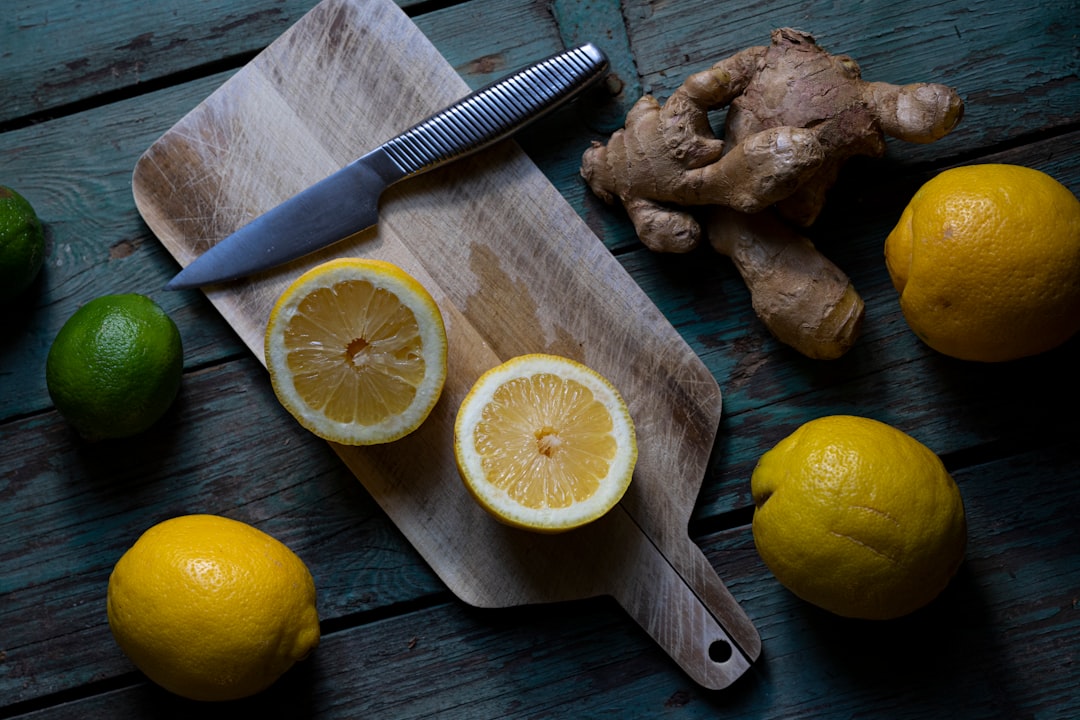 sliced lemon beside sliced lemon on chopping board