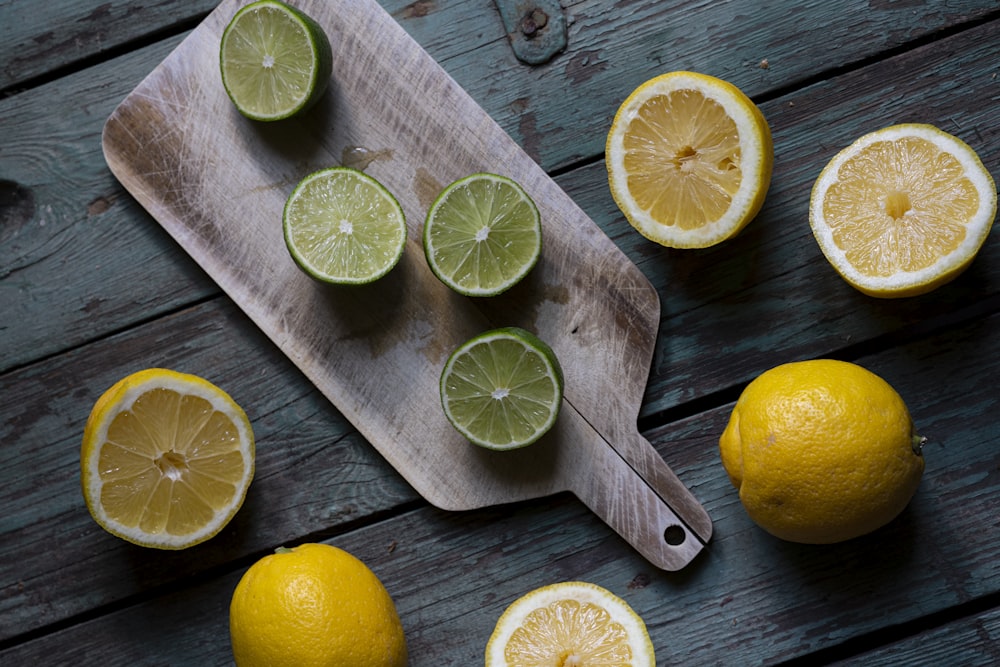 sliced lemon on brown wooden chopping board