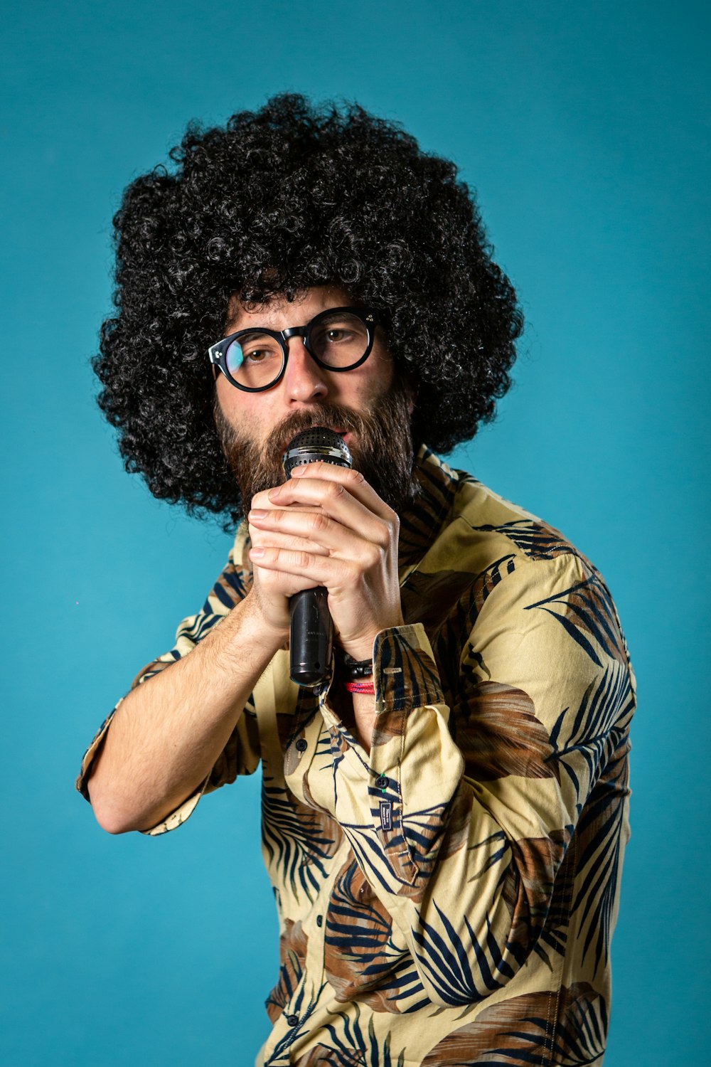 man in brown and black camouflage button up shirt drinking from bottle