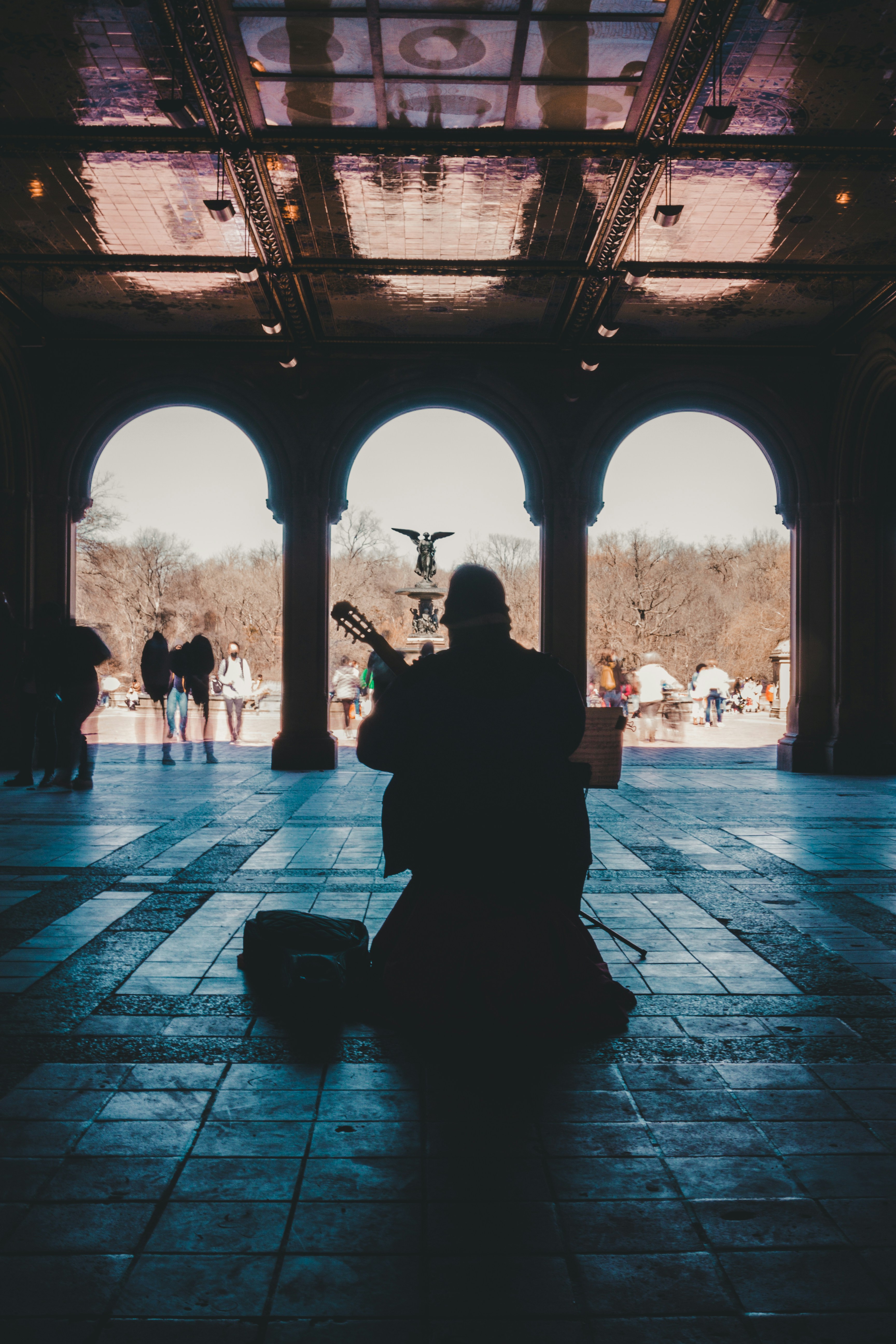man in black jacket sitting on bench