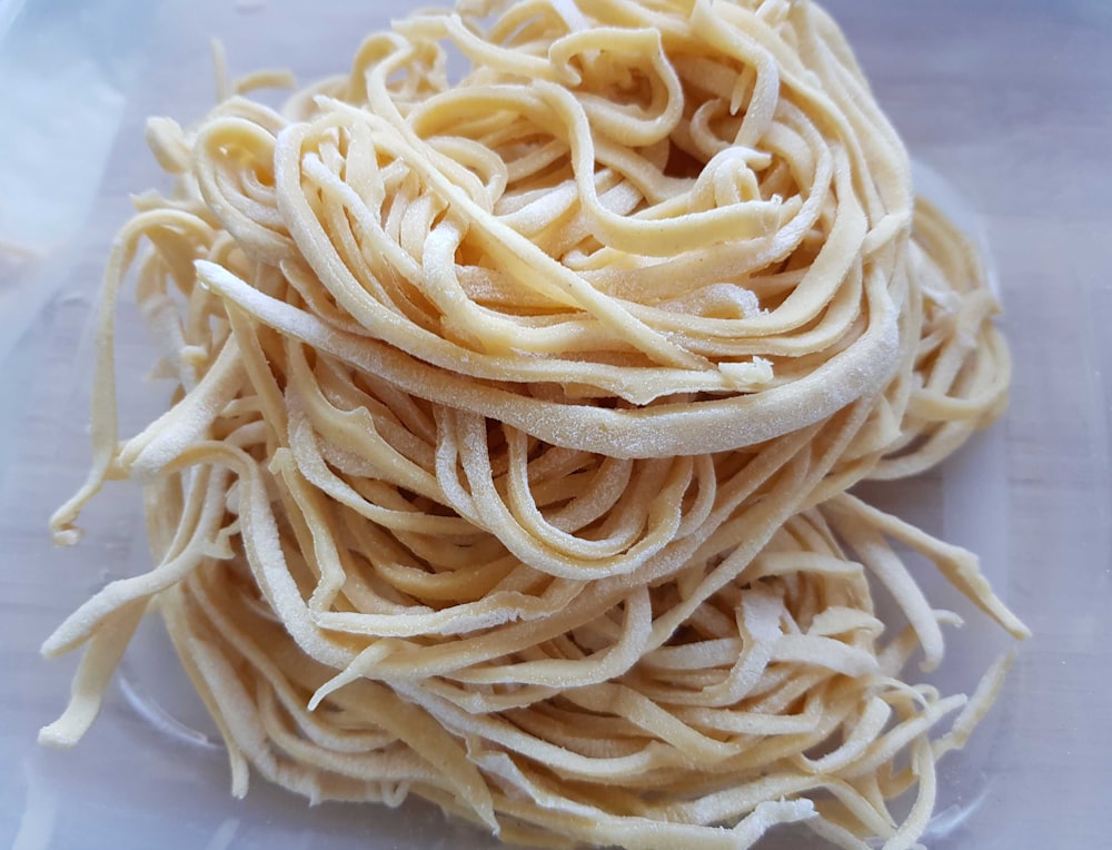 white pasta on white ceramic plate