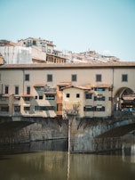 Italtrax truck crossing a historic Italian bridge, blending tradition and modern transport.