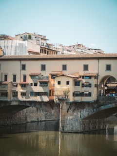 Italtrax truck crossing a historic Italian bridge, blending tradition and modern transport.