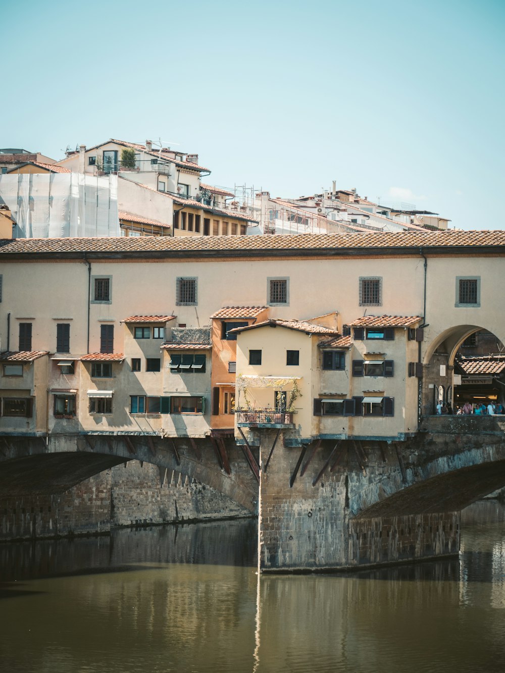 white concrete building beside river during daytime