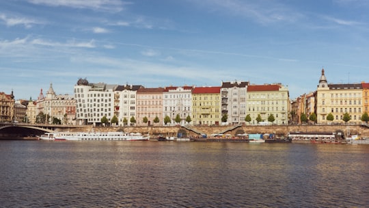 brown and white concrete building near body of water during daytime in Vyšehrad Czech Republic