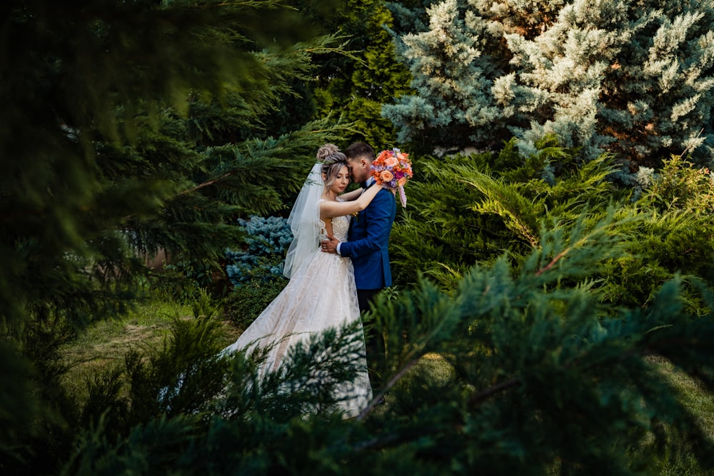 woman in white wedding gown holding flowers