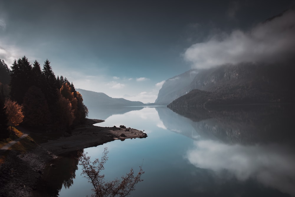 lake in the middle of mountains during daytime