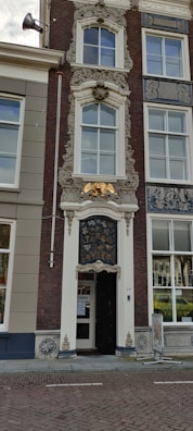 Close-up of intricate gold-accented architectural details on a premium building facade.