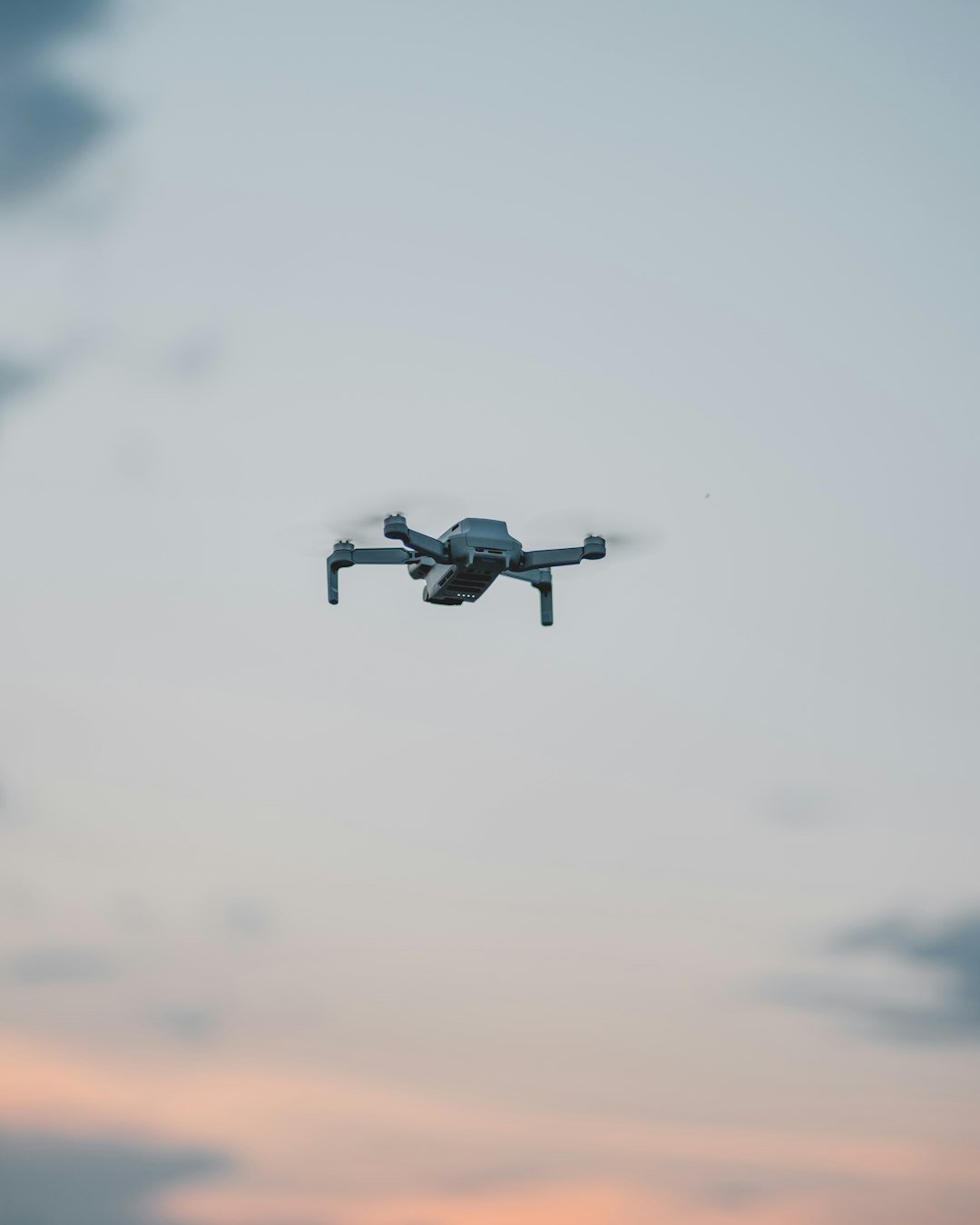 white drone flying in the sky