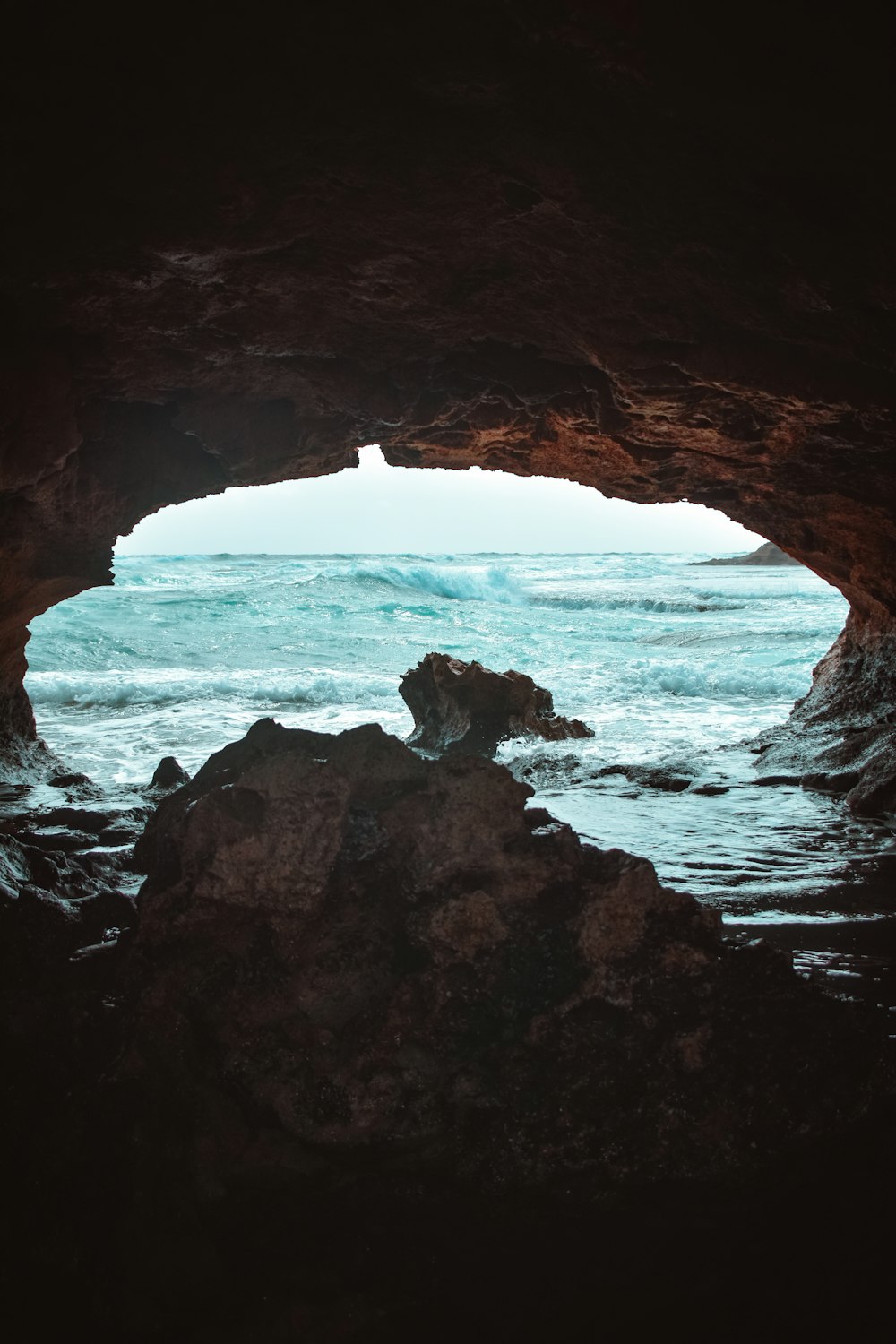 brown rock formation near sea during daytime