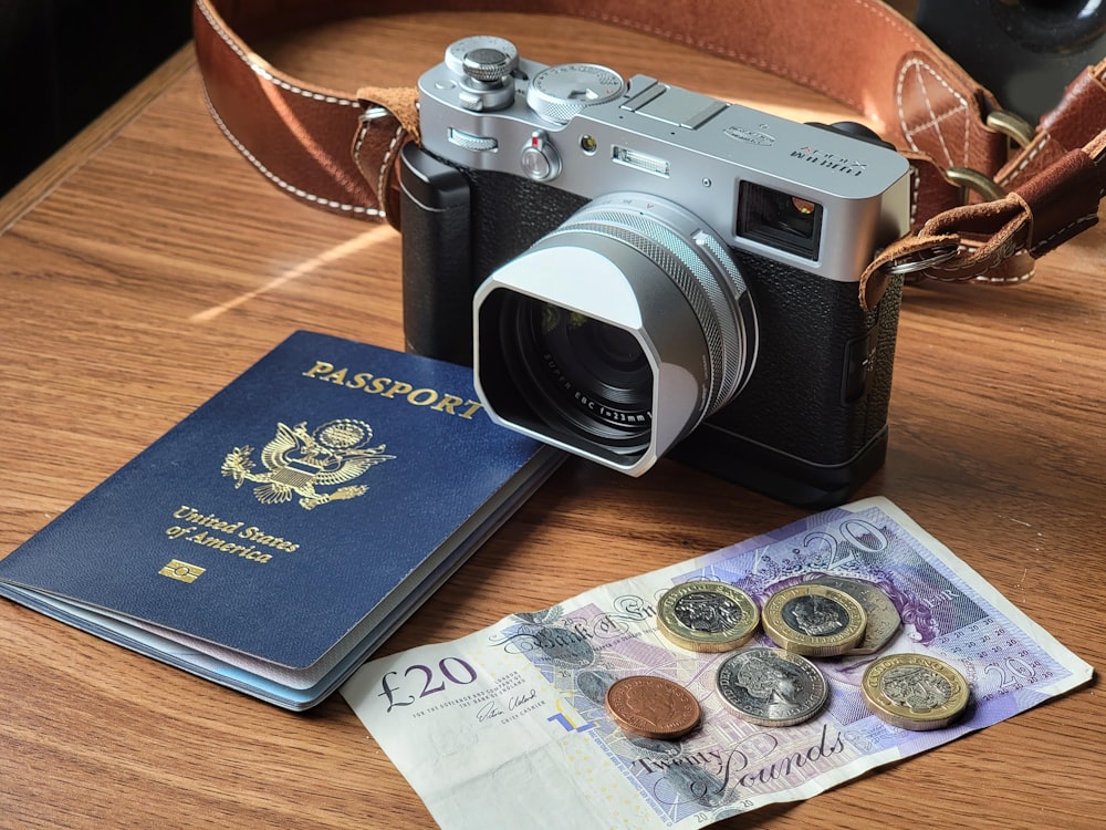 black and silver dslr camera on brown wooden table