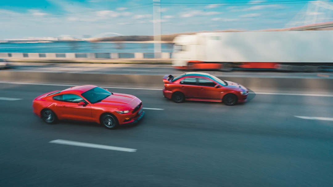 red chevrolet camaro on road during daytime