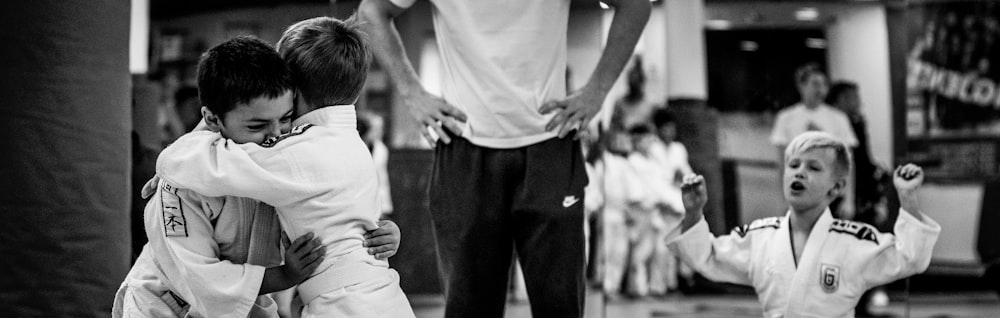 grayscale photo of man in white t-shirt and black pants