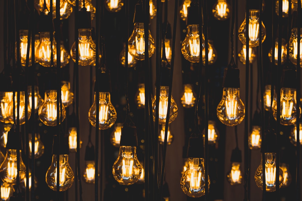 clear glass pendant lamps turned on during night time