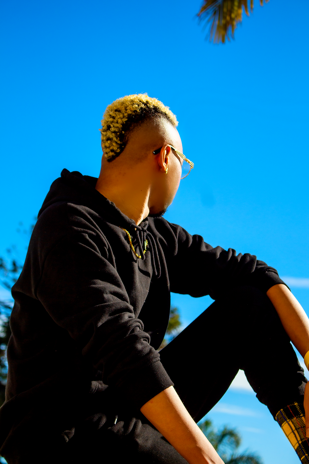 man in black hoodie wearing sunglasses