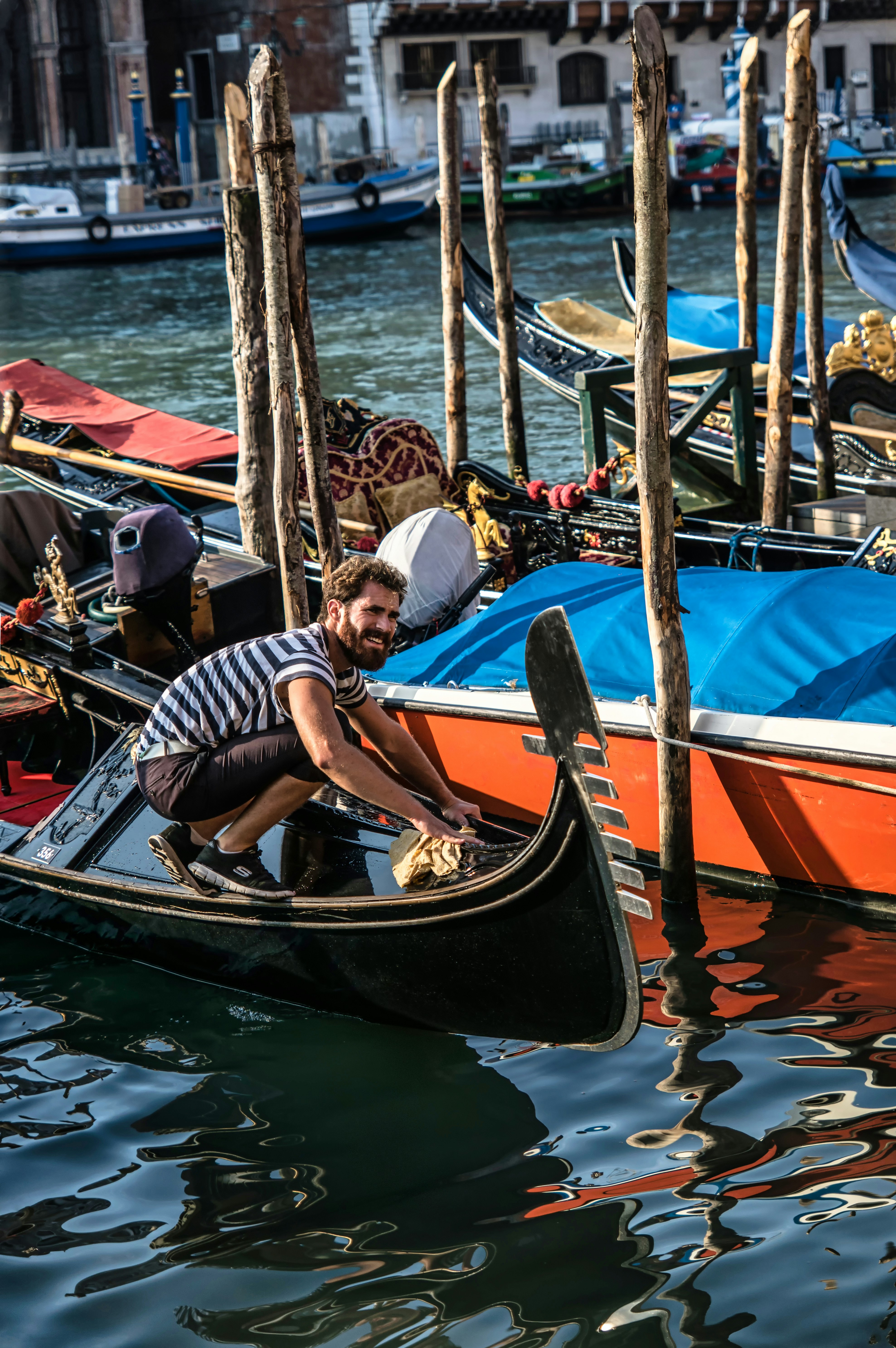 woman in black and white striped shirt riding on boat during daytime