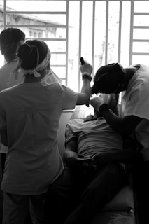 man in white dress shirt sitting beside woman in white dress