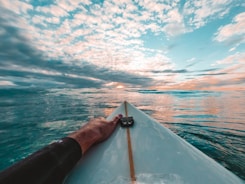 person in black shorts on boat during daytime