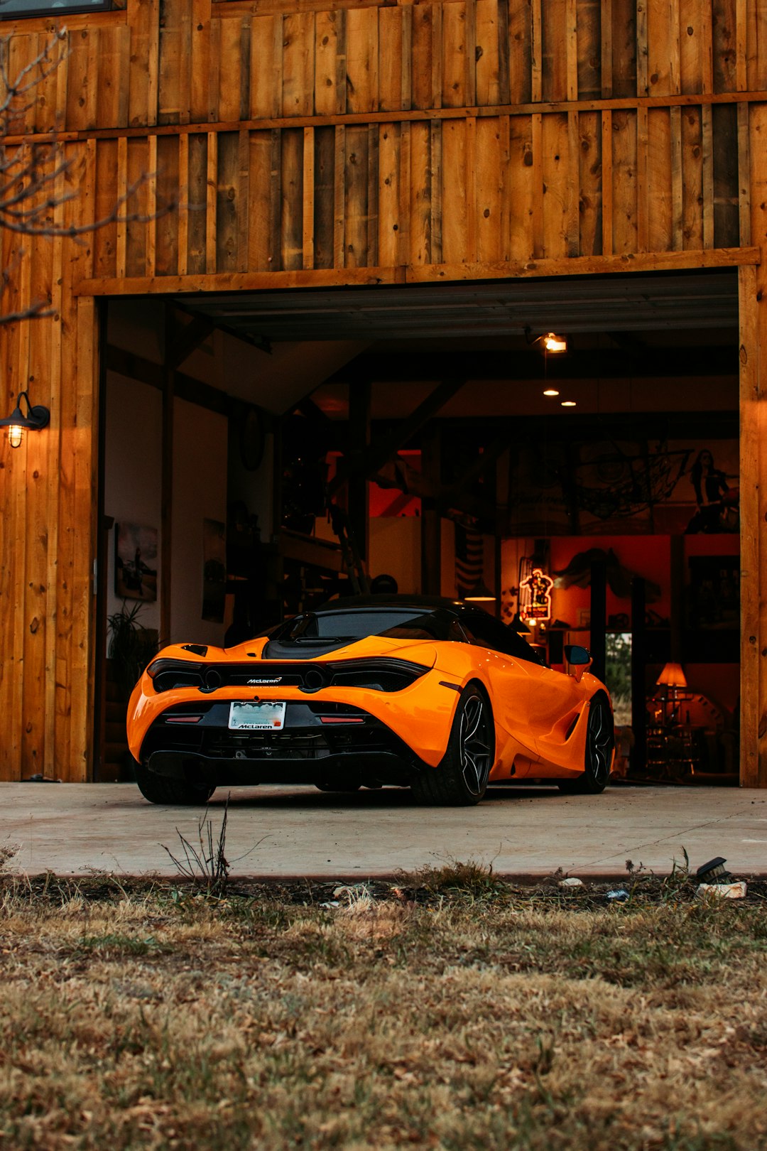 orange lamborghini aventador parked in front of brown wooden building