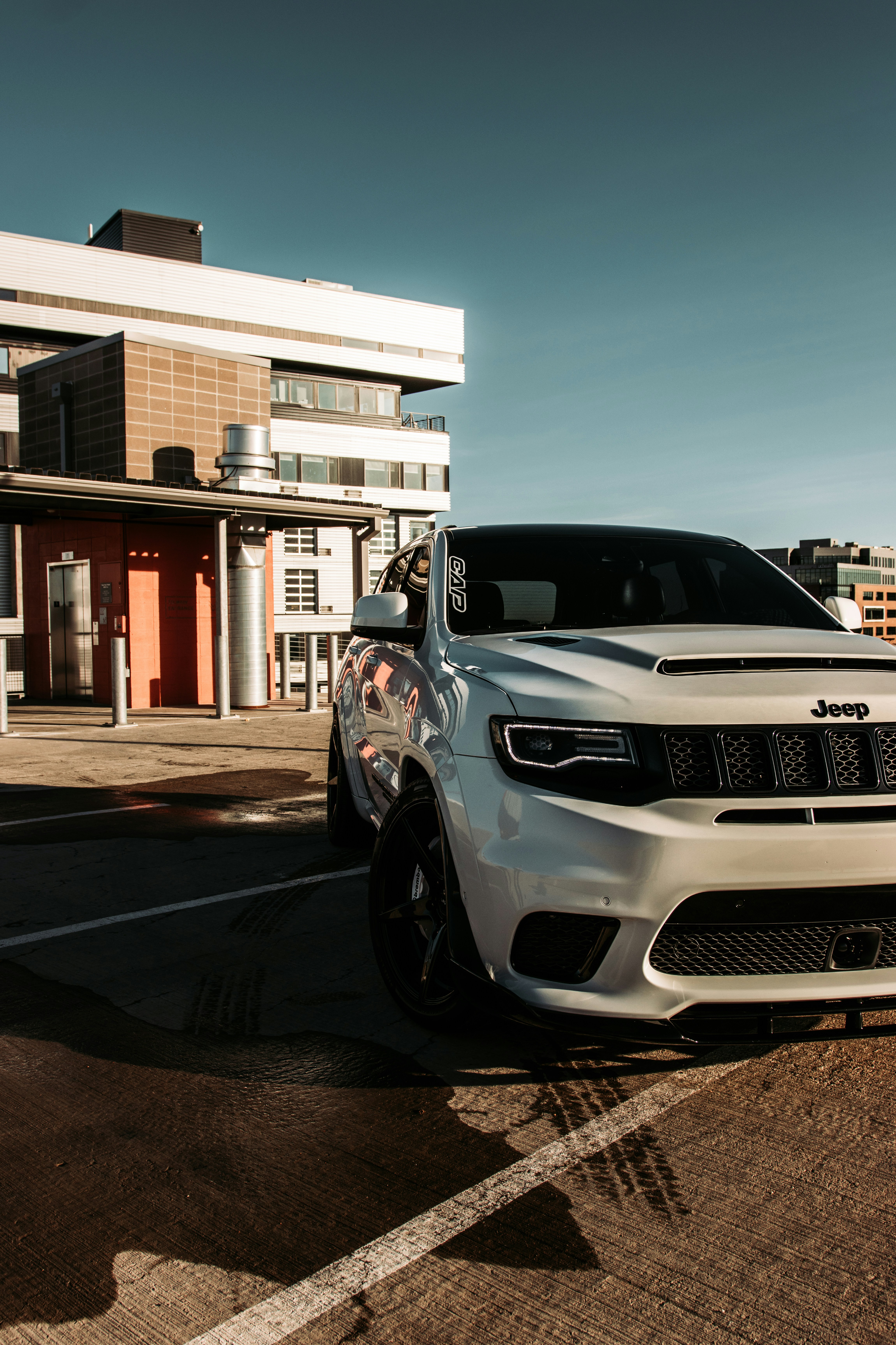 silver car parked in front of white and brown building