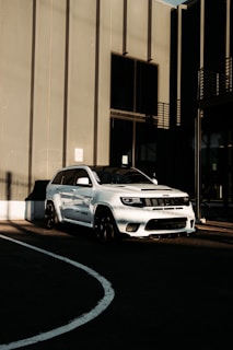 Overhead shot of the Tata Sierra parked beside a sleek urban building, emphasizing its minimalist yet rugged design