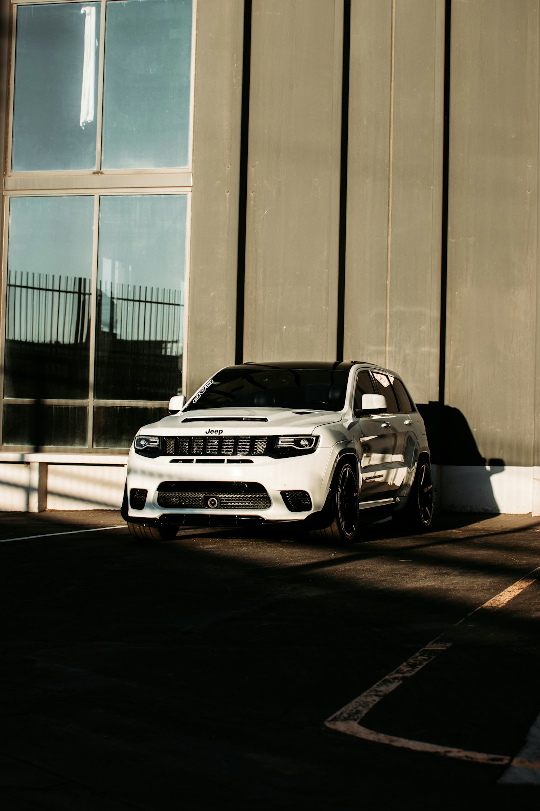 white bmw m 3 coupe parked in front of gray wall