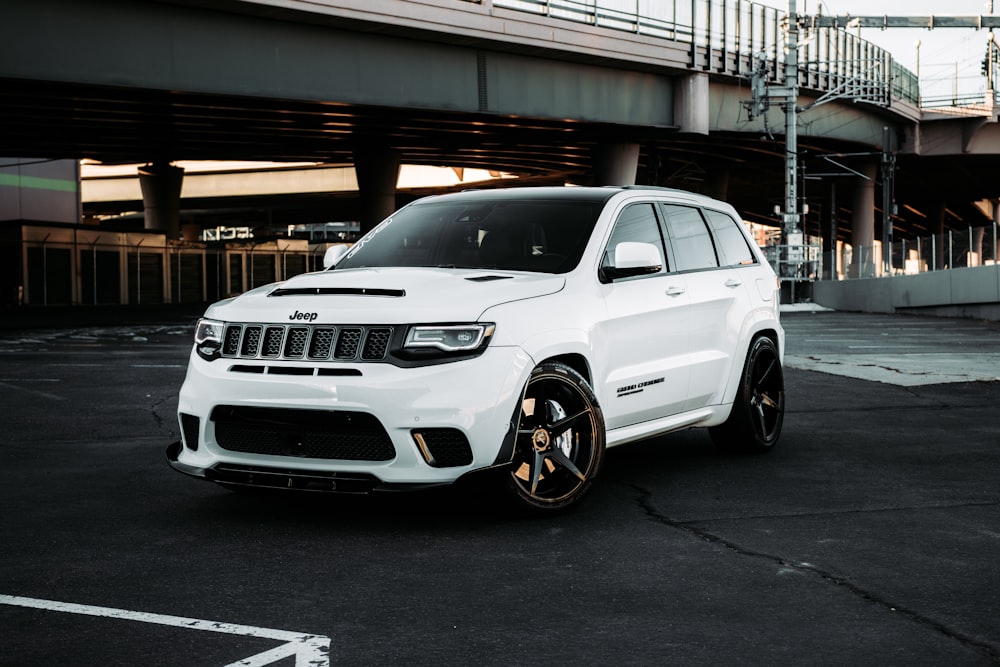 white bmw x 6 parked on parking lot during daytime