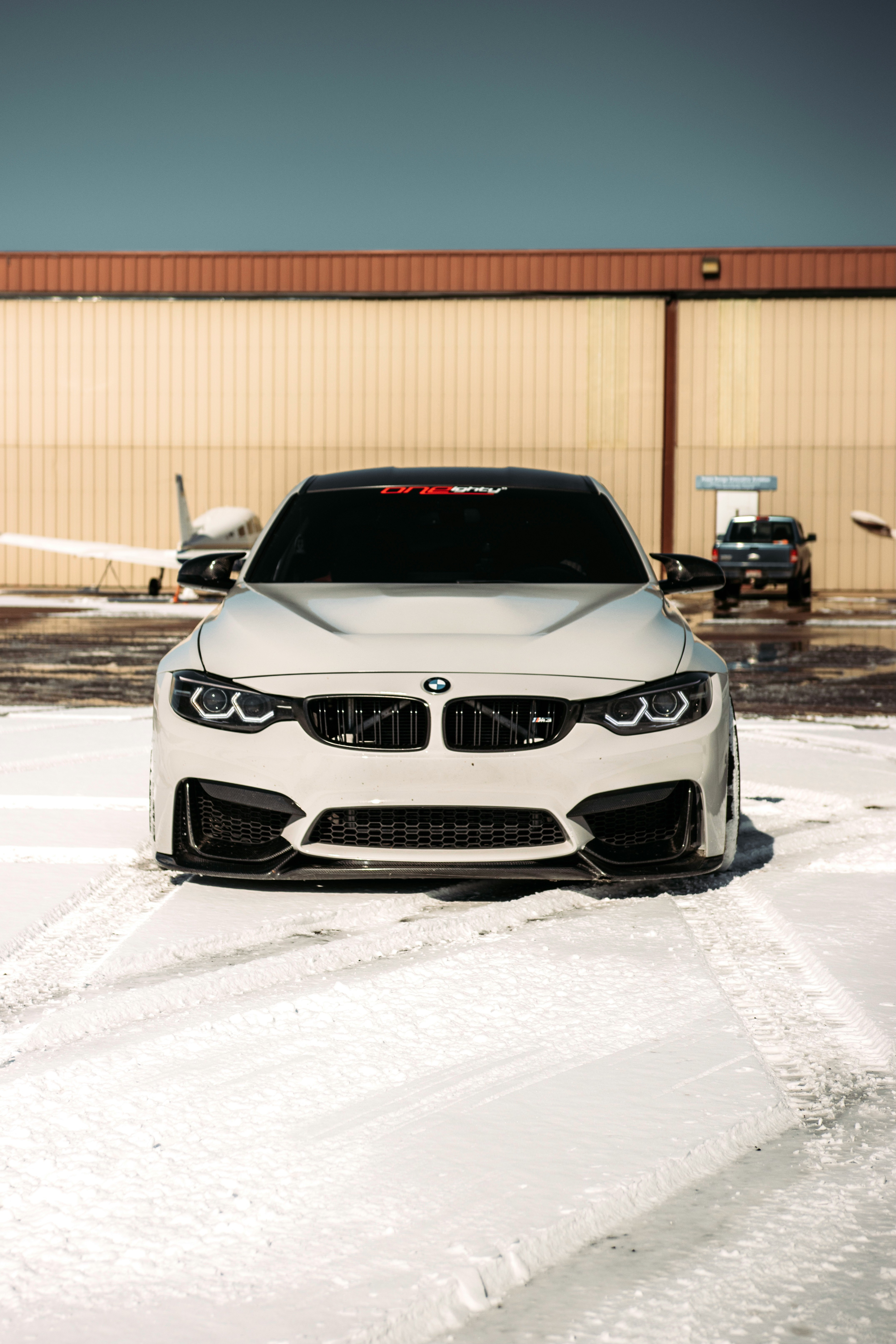 white bmw car on snow covered ground during daytime